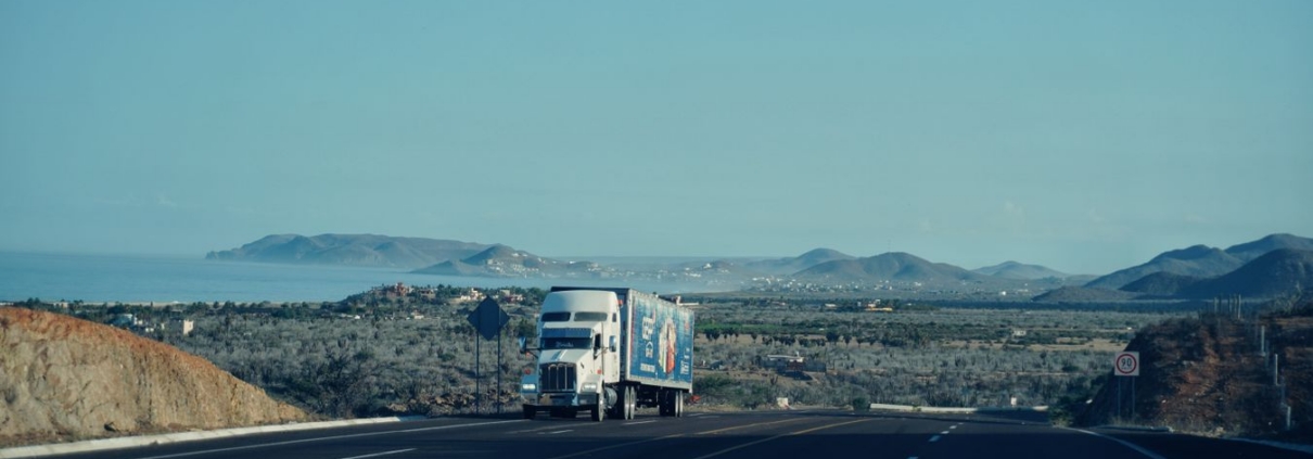 Semi truck driving on a highway, representing commercial trucking and fleet financing
