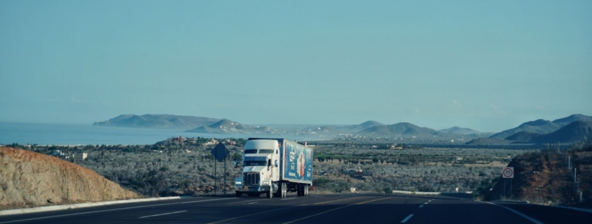 Semi truck driving on a highway, representing commercial trucking and fleet financing