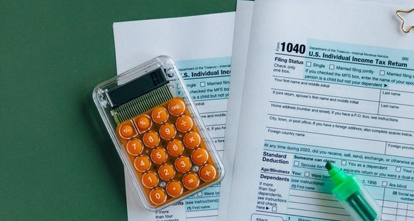Tax forms and a calculator, representing the Section 179 equipment tax deduction