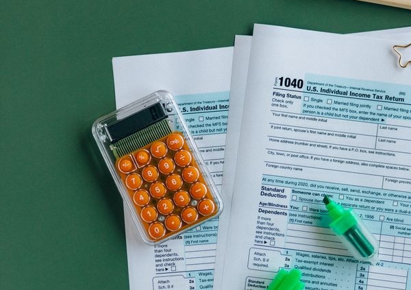 Tax forms and a calculator, representing the Section 179 equipment tax deduction